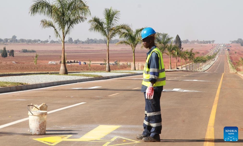 A worker prints lane direction markings on a newly constructed road on the outskirts of Zimbabwe's capital Harare, on July 20, 2024. Zimbabwe is upgrading roads in and around Harare ahead of an August summit of the Southern African Development Community (SADC) in the capital city. (Photo by Tafara Mugwara/Xinhua)