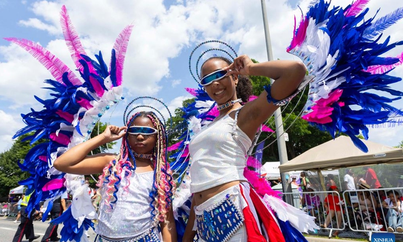 Dressed-up girls pose for photos during the Junior Carnival Parade of the 2024 Toronto Caribbean Carnival in Toronto, Canada, on July 20, 2024. The annual event kicked off here on Saturday with thousands of young participants in vibrant costumes celebrating Caribbean culture with music and dance. (Photo by Zou Zheng/Xinhua)