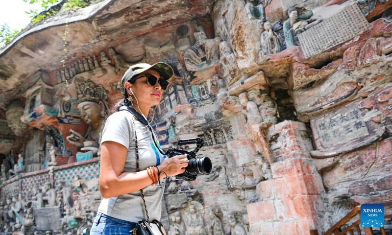 A tourist from abroad visits the scenic spot of Dazu Rock Carvings in southwest China's Chongqing, July 19, 2024.

Chongqing is soaring as a favored entry point for foreign tourists. This municipality has received more than 510,000 inbound foreign visitors in the first half of this year. (Xinhua/Wang Quanchao)