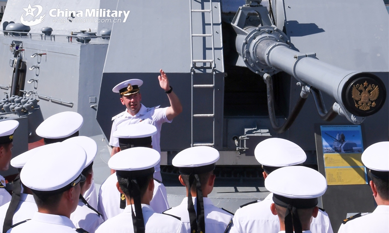 A Russian naval officer introduces the Russian naval corvette Gromkiy to visiting Chinese sailors during the China-Russia joint naval exercise coded Exercise Joint Sea-2024 on July 13, 2024. (eng.chinamil.com.cn/Photo by Luan Cheng)