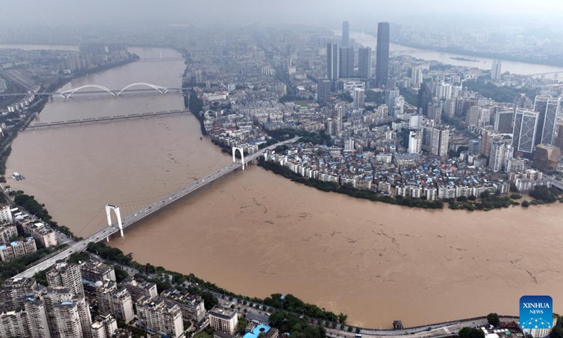 An aerial drone photo taken on June 19, 2024 shows surging water flow of the Liujiang River in Liuzhou City, south China's Guangxi Zhuang Autonomous Region. Due to heavy rainfall, water level at the Liuzhou hydrological station on the Liujiang River in Guangxi rose to 86.3 meters at 9:40 a.m. Wednesday, exceeding the alert line by 3.8 meters.(Photo: Xinhua)