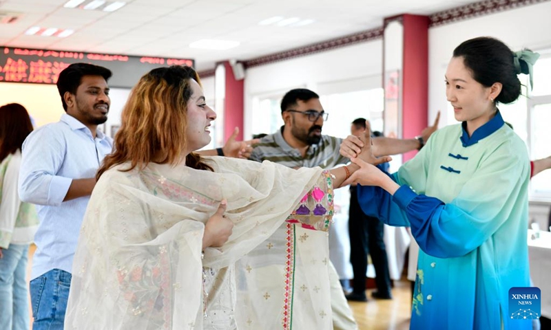 International students from Qingdao University learn Baduanjin, a traditional form of Chinese aerobic exercise, at a traditional Chinese medicine (TCM) hospital in Qingdao, east China's Shandong Province, June 18, 2024. Some international students from Qingdao University visited a local TCM hospital on Tuesday to experience the charm of TCM culture. Collaborated with several universities in the city, the hospital built a TCM experience base that has hosted more than 600 international students. (Photo: Xinhua)