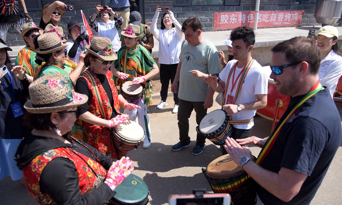 Foreign tourists interact with local fishermen and perform folk dances at Quge village, Rongcheng city, East China's Shandong Province, on June 6, 2024. Photo: VCG