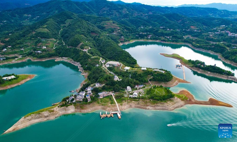 An aerial drone photo taken on June 21, 2024 shows the scenery of Yinghu Lake scenic spot in Ankang, northwest China's Shaanxi Province. Water quality of Yinghu Lake has improved significantly in recent years, and the forest coverage rate along its shore has reached 76 percent. (Xinhua/Cai Xiangxin)