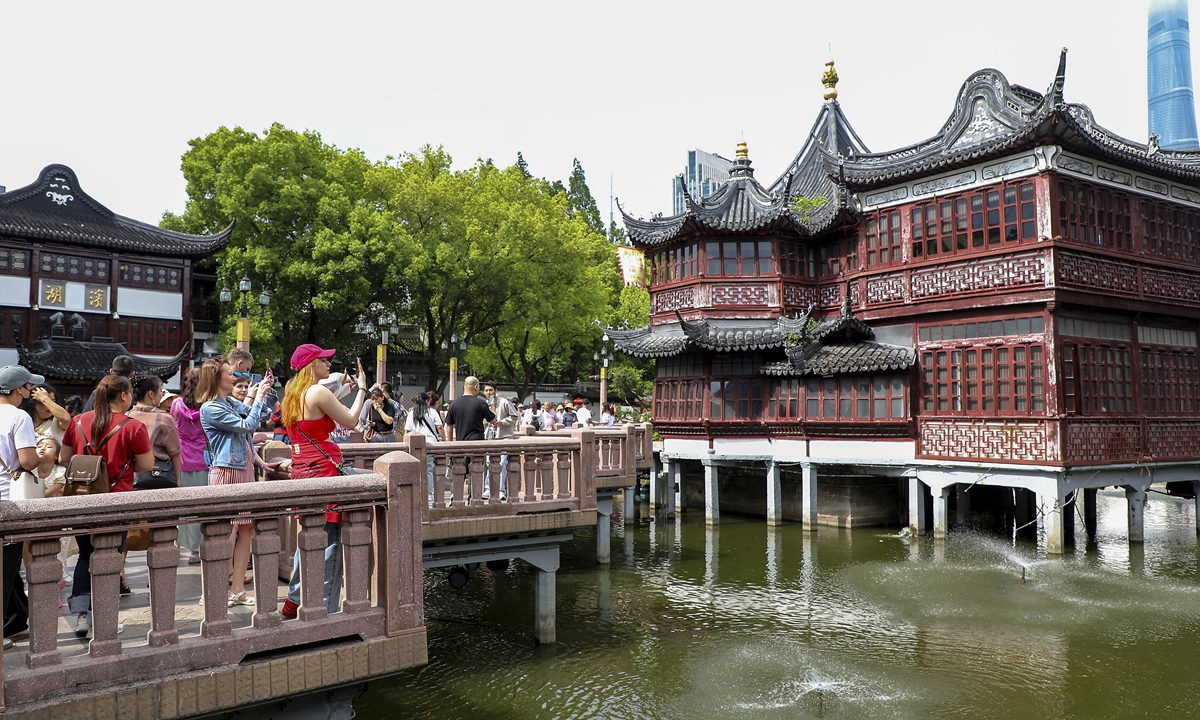 Tourists take photos of the Nine-turning Bridge in Yuyuan Garden in Shanghai on May 20, 2024. Photo: VCG
