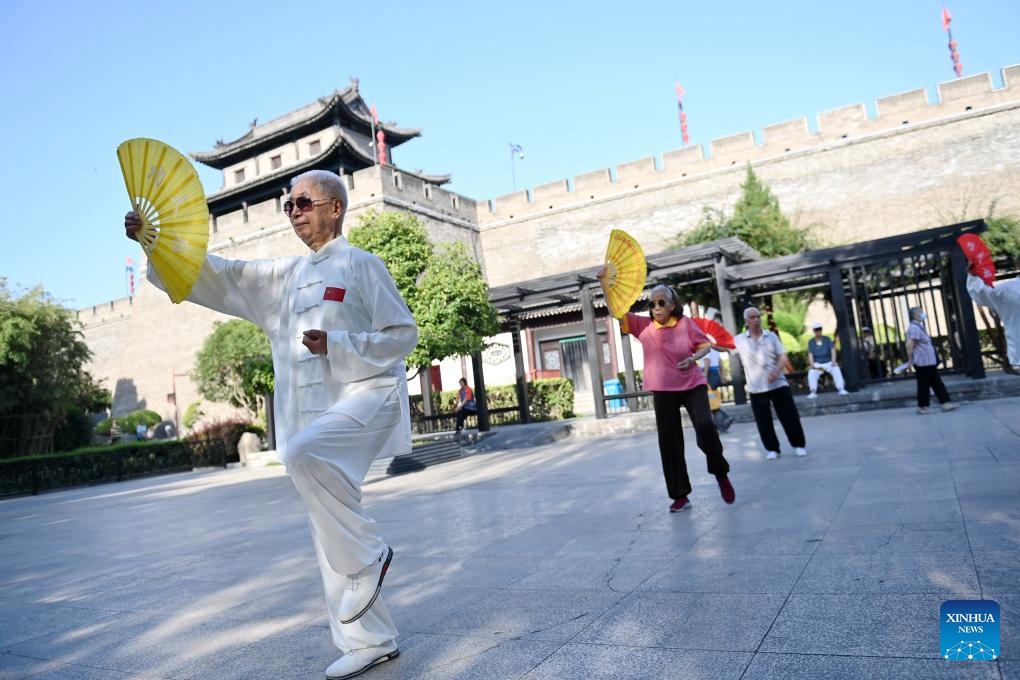 Photo taken on June 12, 2024 shows residents practicing Taiji near ancient city wall in Xi'an, northwest China's Shaanxi Province. Xi'an, a city with over 3,100 years of history, served as the capital for 13 dynasties in Chinese history. It is also home to the world-renowned Terracotta warriors created in the Qin Dynasty (221-207 BC).(Photo: Xinhua)