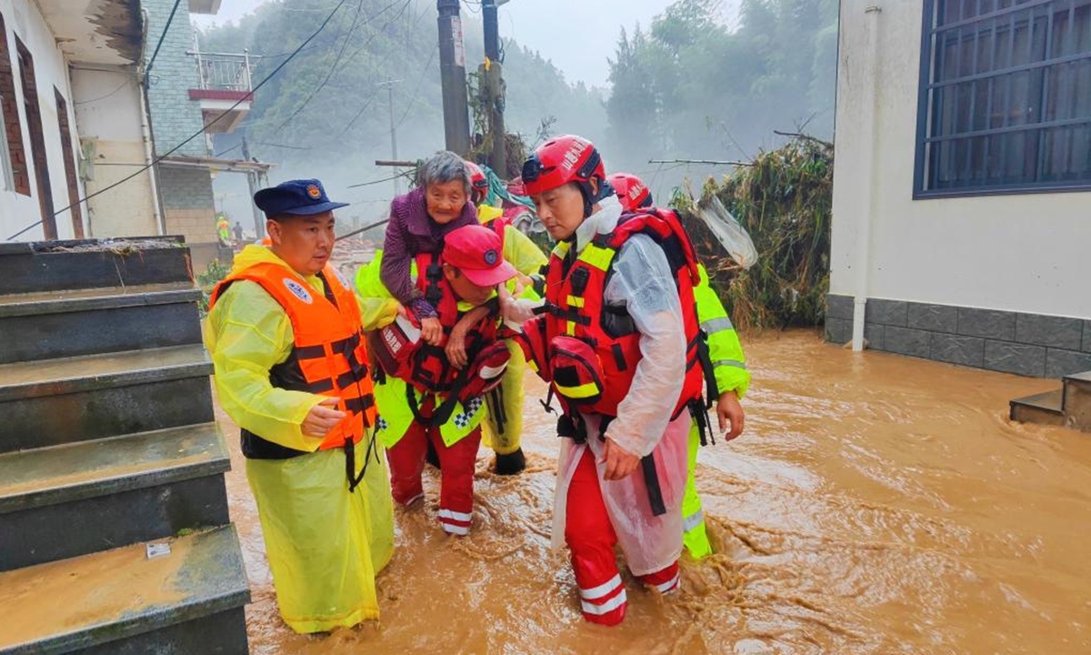 Rescuers transfer a flood-affected resident in Shexian County of Huangshan, East China's Anhui Province, June 20, 2024. In Huangshan City of east China's Anhui Province, due to intense downpours, some 2,110 residents had been relocated as of 9 a.m. Thursday, according to the local flood control and drought relief headquarters. Photo: Xinhua