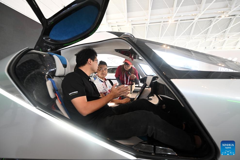 A visitor learns about an aircraft at the booth of Xpeng Aeroht at the World Intelligence Expo 2024 in north China's Tianjin, June 20, 2024. The World Intelligence Expo 2024 opened on Thursday in Tianjin. With the theme of Intelligence: Extensive Development Space, Sustainable Growth Driver, the expo is co-hosted by the Tianjin municipal government and Chongqing municipal government.(Photo: Xinhua)