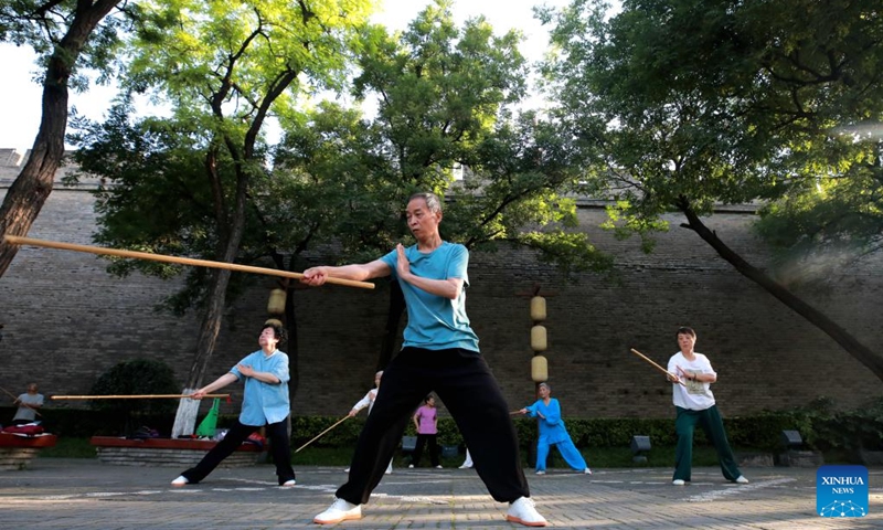 Photo taken on June 12, 2024 shows residents practicing Wushu near ancient city wall in Xi'an, northwest China's Shaanxi Province. Xi'an, a city with over 3,100 years of history, served as the capital for 13 dynasties in Chinese history. It is also home to the world-renowned Terracotta warriors created in the Qin Dynasty (221-207 BC).(Photo: Xinhua)