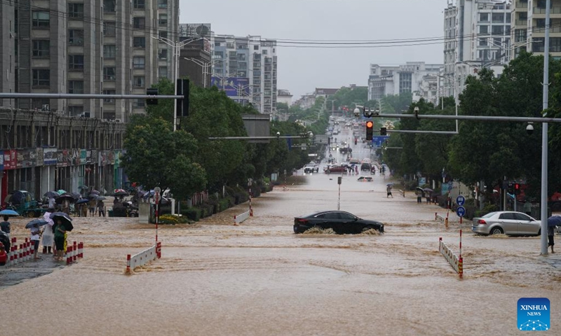 Vehicles move on a waterlogged road in Shexian County, Huangshan City, east China's Anhui Province, June 23, 2024. Rainstorms hit Huangshan City on Sunday. (Photo: Xinhua)