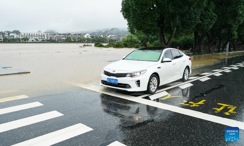 A vehicle is seen on a waterlogged road in Shexian County, Huangshan City, east China's Anhui Province, June 23, 2024. Rainstorms hit Huangshan City on Sunday. (Photo: Xinhua)