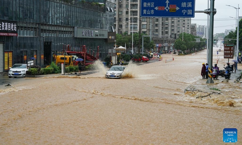 A vehicle moves on a waterlogged road in Shexian County, Huangshan City, east China's Anhui Province, June 23, 2024. Rainstorms hit Huangshan City on Sunday. (Photo: Xinhua)