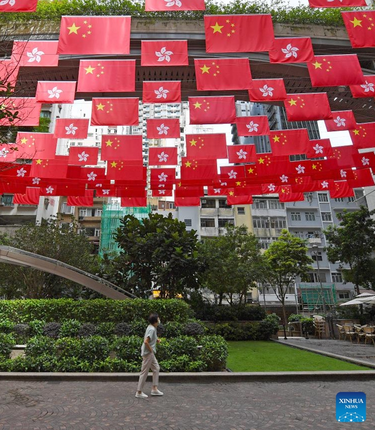 China's national flags and the flags of the Hong Kong Special Administrative Region are seen at a street in Hong Kong, south China, June 23, 2024. This year marks the 27th anniversary of Hong Kong's return to the motherland. (Photo: Xinhua)