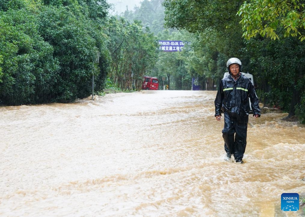 A person walks on a waterlogged road in Shexian County, Huangshan City, east China's Anhui Province, June 23, 2024. Rainstorms hit Huangshan City on Sunday. (Photo: Xinhua)