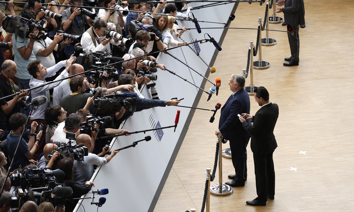 Hungary's Prime Minister Viktor Orban (center left) speaks with the media as he arrives for an EU summit in Brussels on June 27, 2024. Hungary will take over EU presidency since July 1. EU leaders are set to discuss the next EU top jobs, as well as the situations in the Middle East and Ukraine at the summit. Photo: VCG