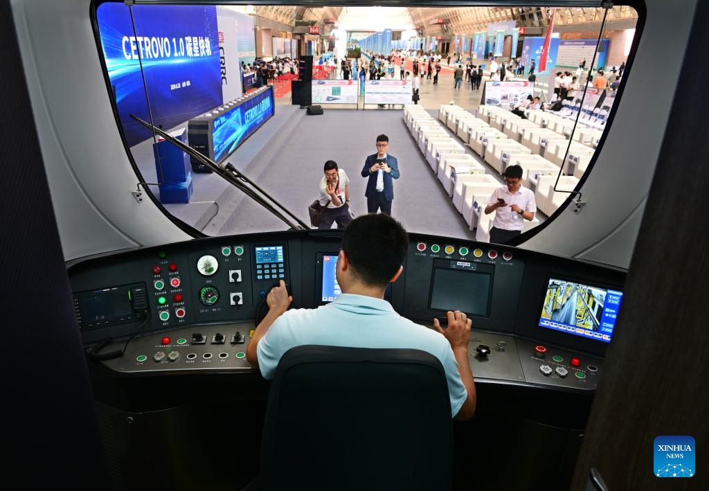 A visitor takes a look inside the cockpit of a CETROVO 1.0 subway car in Qingdao, east China's Shandong Province, June 26, 2024. The CETROVO 1.0 subway car was launched in Qingdao on Wednesday. With a carbon fiber composite body and frame, it is lighter and more energy-efficient than the traditional subway train.(Photo: Xinhua)