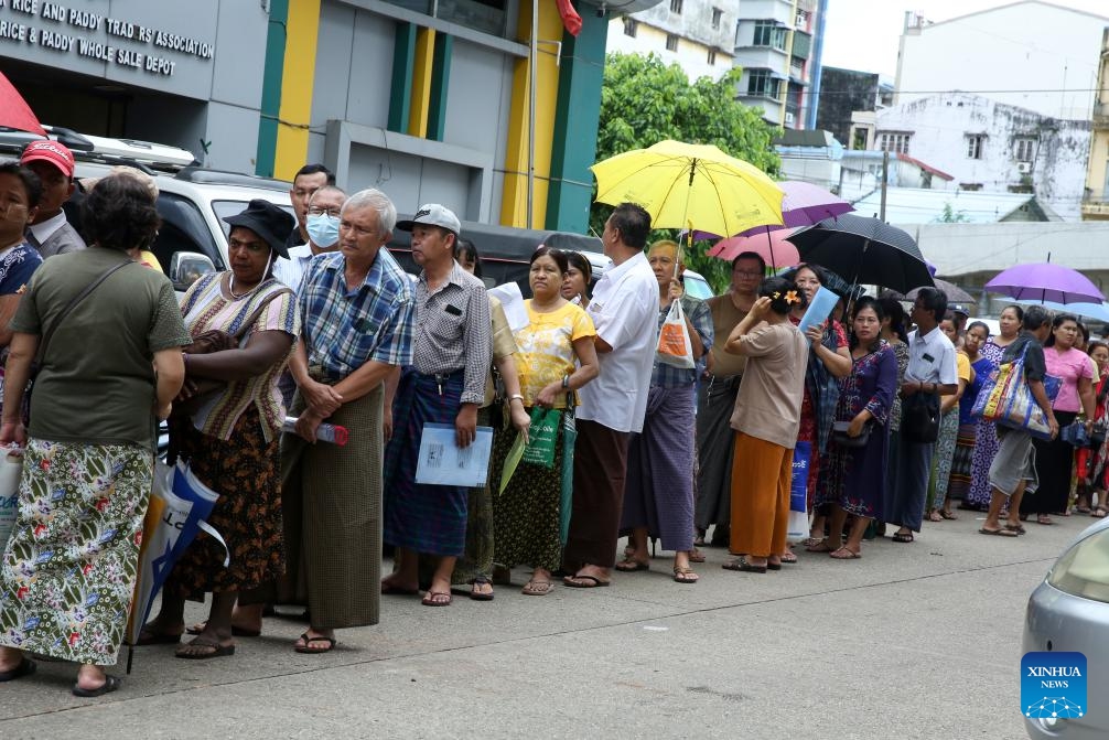 People stand in a queue to buy rice outside the Rice and Paddy Wholesale Depot in Yangon, Myanmar, June 25, 2024.(Photo: Xinhua)