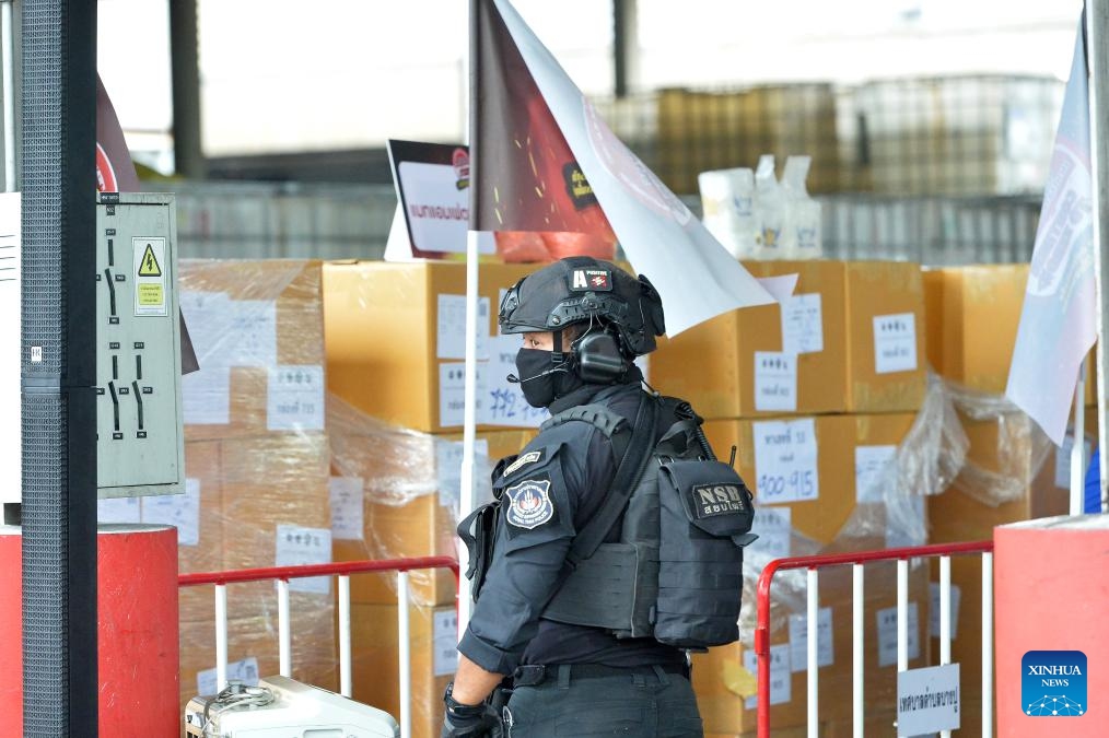 A police officer stands guard in front of the illegal drugs to be burned at Bang Pu in Thailand's Samut Prakan Province, June 26, 2024. Thailand burned more than 20 tons of confiscated narcotic drugs worth 6.45 billion baht (about 175 million U.S. dollars) on Wednesday to mark the International Day Against Drug Abuse and Illicit Trafficking, authorities said.(Photo: Xinhua)