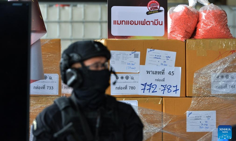 A police officer stands guard in front of the illegal drugs to be burned at Bang Pu in Thailand's Samut Prakan Province, June 26, 2024. Thailand burned more than 20 tons of confiscated narcotic drugs worth 6.45 billion baht (about 175 million U.S. dollars) on Wednesday to mark the International Day Against Drug Abuse and Illicit Trafficking, authorities said.(Photo: Xinhua)