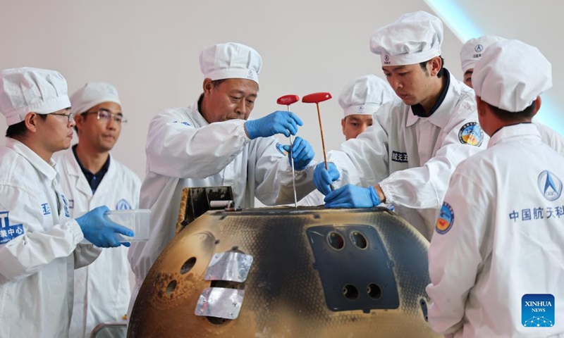 The returner of the Chang'e-6 lunar probe is opened during a ceremony at the China Academy of Space Technology under the China Aerospace Science and Technology Corporation in Beijing, capital of China, June 26, 2024. The returner of the Chang'e-6 lunar probe was opened at a ceremony in Beijing on Wednesday afternoon. During the ceremony at the China Academy of Space Technology under the China Aerospace Science and Technology Corporation, researchers opened the returner and examined key technical indicators.(Photo: Xinhua)