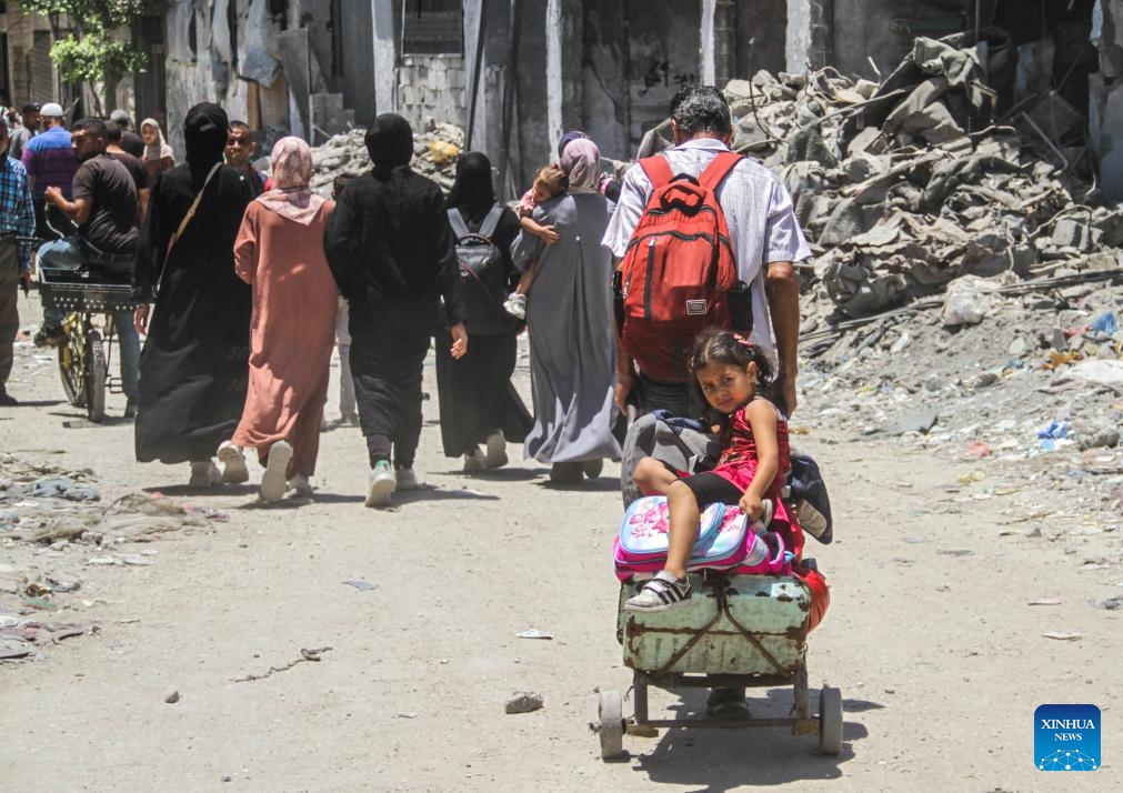 People leave their home in the neighborhood of Shuja'iya in the east of Gaza City, on June 27, 2024. The Israeli army on Thursday ordered residents of neighborhoods in eastern Gaza City to evacuate immediately amid the incursion of its military forces into the areas. (Photo: Xinhua)
