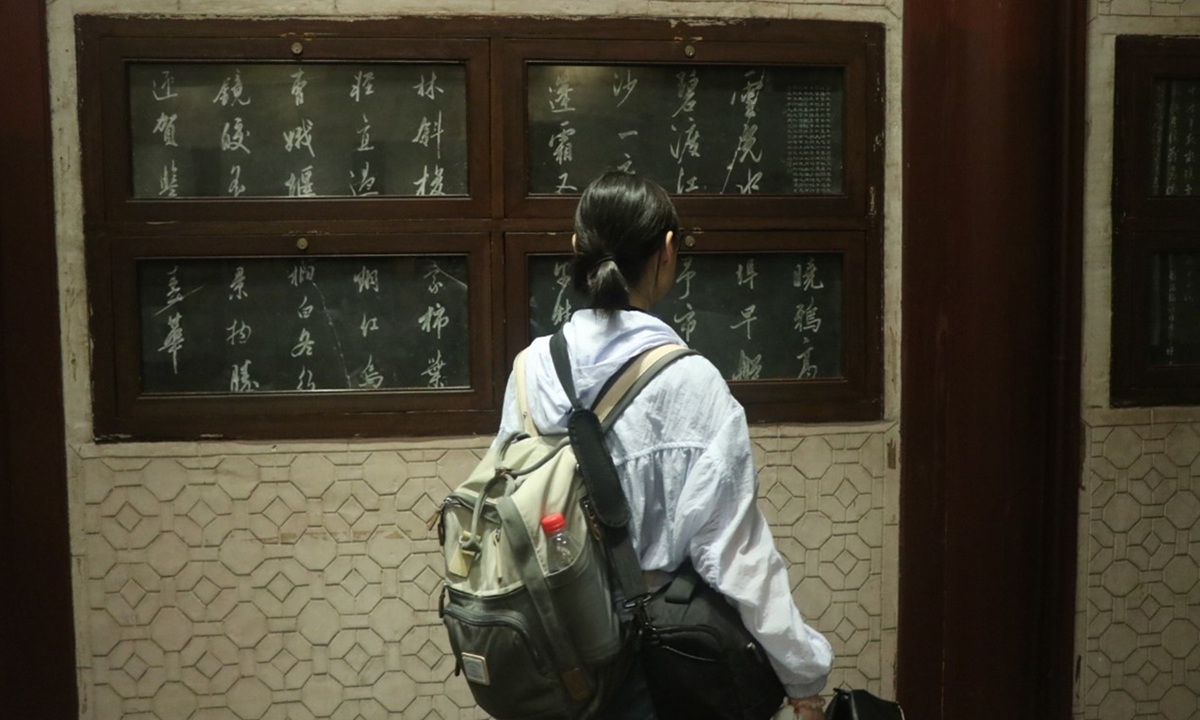 A tourist reads inscriptions inside Tianyige library in Ningbo, East China's Zhejiang Province. Photo: Zhu Xiaoyi
