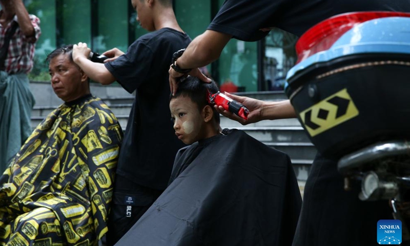 Young hairdressers from Myanmar Barber Academy offer free haircuts in Botataung Township of Yangon, Myanmar, June 29, 2024.(Xinhua/Myo Kyaw Soe)