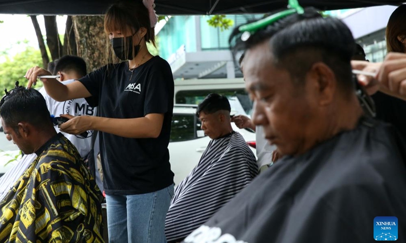 Young hairdressers from Myanmar Barber Academy offer free haircuts in Botataung Township of Yangon, Myanmar, June 29, 2024. (Xinhua/Myo Kyaw Soe)