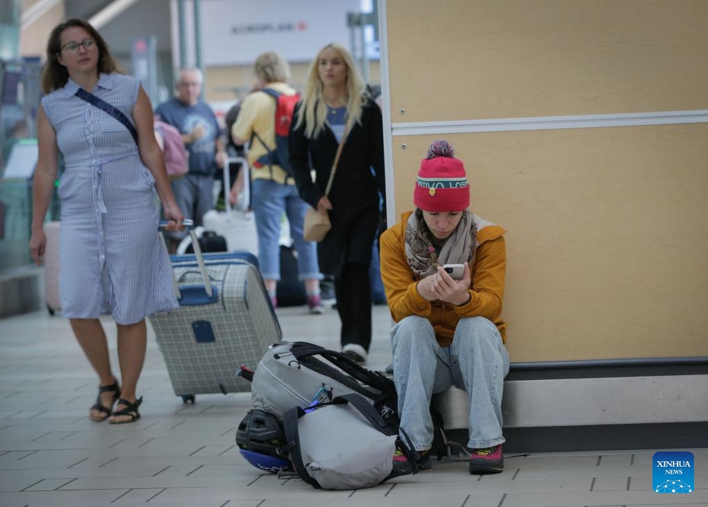 A traveller waits for a flight at Vancouver International Airport in Richmond, British Columbia, Canada, June 29, 2024. Canada's second largest airline, the WestJet Group, said Friday it is outraged at an unexpected strike by its aircraft maintenance engineers.
