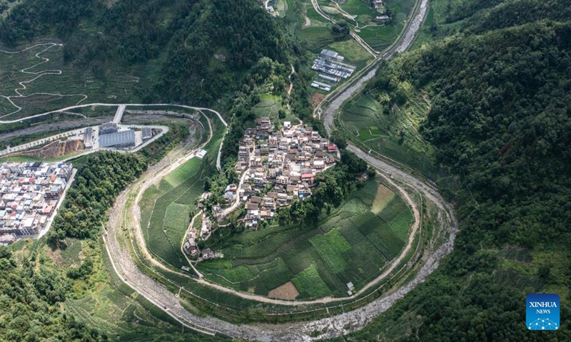 An aerial drone photo taken on June 26, 2023 shows a rural road in Jiaona Township of Wangmo County, Bouyei-Miao Autonomous Prefecture of Qianxinan, southwest China's Guizhou Province. In the past ten years, the rural road network in Guizhou Province has been significantly improved. By the end of 2023, the total mileage of rural roads in Guizhou has reached 185,000 kilometers. (Xinhua/Tao Liang)