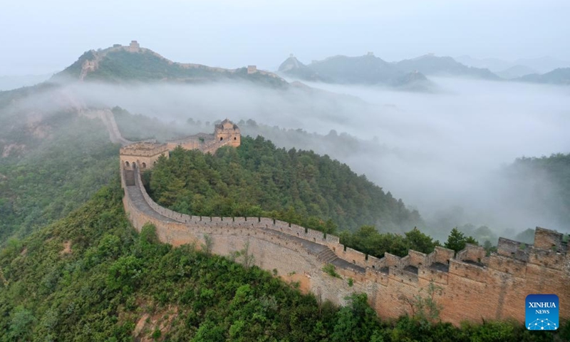 An aerial drone photo taken on June 30, 2024 shows the Jinshanling section of the Great Wall shrouded in clouds after the rain in Luanping County, Chengde City, north China's Hebei Province. (Photo by Zhou Wanping/Xinhua)