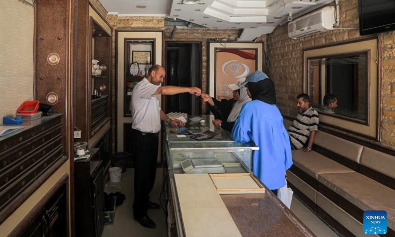 People are seen at a gold shop in the southern Gaza Strip city of Khan Younis, on June 26, 2024. (Photo by Rizek Abdeljawad/Xinhua)
