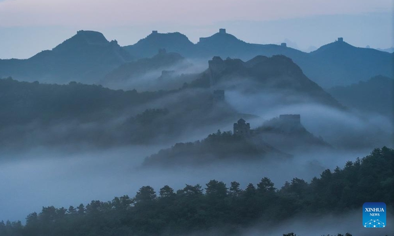 An aerial drone photo taken on June 30, 2024 shows the Jinshanling section of the Great Wall shrouded in clouds after the rain in Luanping County, Chengde City, north China's Hebei Province. (Photo by Liu Mancang/Xinhua)