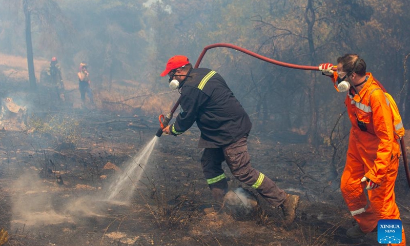 Firefighters try to put out a fire in the forest at Keratea, southeast of Athens, Greece, June 30, 2024.Since the start of the wildfire season on May 1, firefighters are called to handle dozens of wildfires every day across the country. (Xinhua/Marios Lolos)