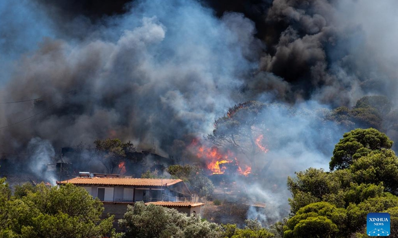 Smoke rises from a wildfire at Keratea, southeast of Athens, Greece, June 30, 2024.Since the start of the wildfire season on May 1, firefighters are called to handle dozens of wildfires every day across the country. (Xinhua/Marios Lolos)