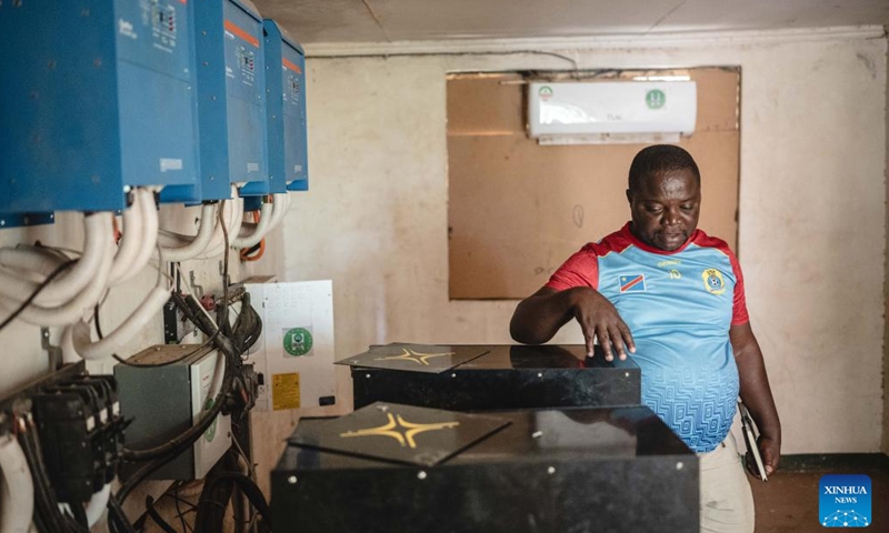 Vasco Hamisi checks the equipment for solar power in Kakuma refugee camp in Turkana, Kenya, June 19, 2024. (Xinhua/Wang Guansen)