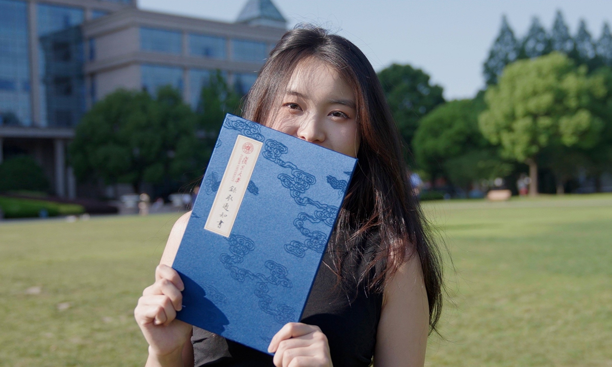 A student gestures with the new acceptance letter from Fudan University Photo: Courtesy of Fudan University