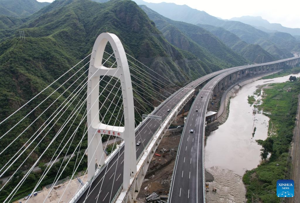 An aerial drone photo taken on July 1, 2024 shows the Beijing section of the Beijing-Yuxian Expressway in Beijing, capital of China. The Beijing section of the Beijing-Yuxian Expressway officially opened to traffic on Monday, reducing road travel time from the Junzhuang interchange on Beijing's west sixth ring road to Lingshan Mountain from 2 hours to 45 minutes. The expressway section will help lower traffic pressure in both the northwest and the southwest of Beijing.(Photo: Xinhua)