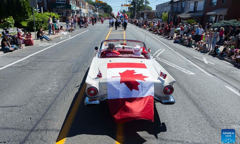 A vehicle covered with a Canadian flag runs during the 2024 Canada Day Parade in Toronto, Canada, on July 1, 2024. (Photo: Xinhua)