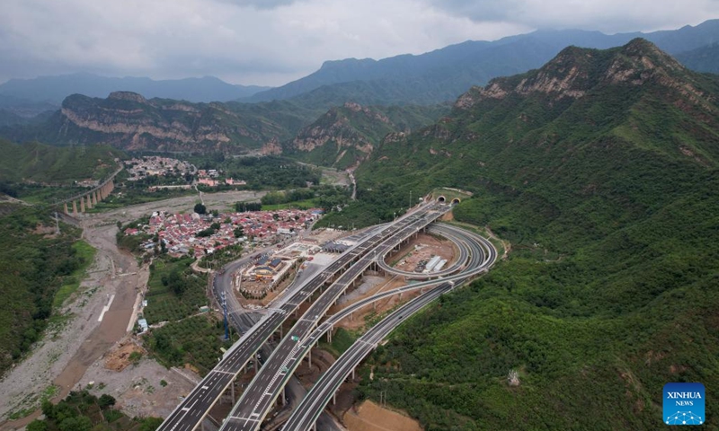 An aerial drone photo taken on July 1, 2024 shows the Beijing section of the Beijing-Yuxian Expressway in Beijing, capital of China. The Beijing section of the Beijing-Yuxian Expressway officially opened to traffic on Monday, reducing road travel time from the Junzhuang interchange on Beijing's west sixth ring road to Lingshan Mountain from 2 hours to 45 minutes. The expressway section will help lower traffic pressure in both the northwest and the southwest of Beijing.(Photo: Xinhua)