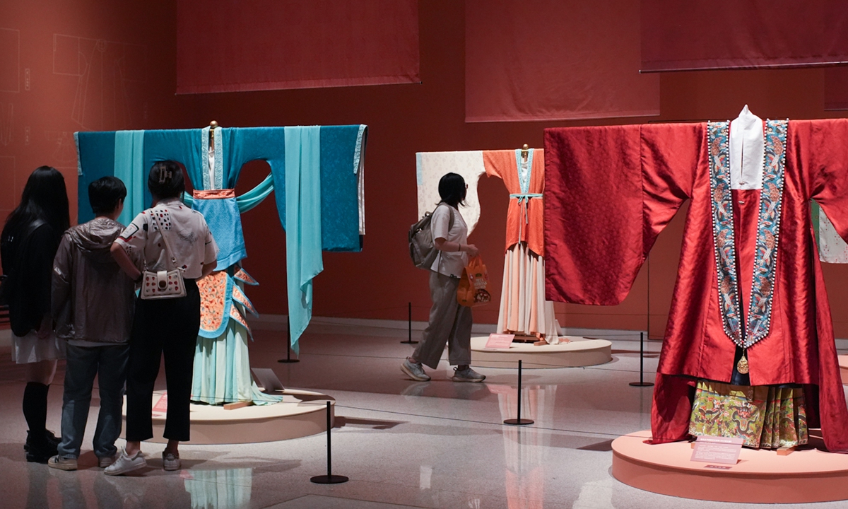 Visitors explore traditional Chinese clothing at a Chinese clothing culture exhibition at the China Craft and Art Museum in Beijing on July 3, 2024. The exhibition, which will run until September 8, showcases the various styles of Chinese clothing from different periods and regions. Photo: VCG