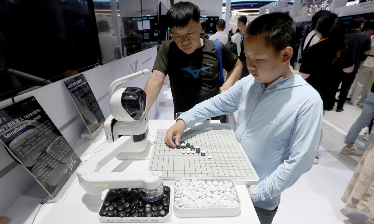A visitor plays go with SenseRobot Go, an AI robot developed by Chinese AI software company SenseTime, at WAIC 2024 in Shanghai on July 4, 2024. Photo: Chen Xia/GT