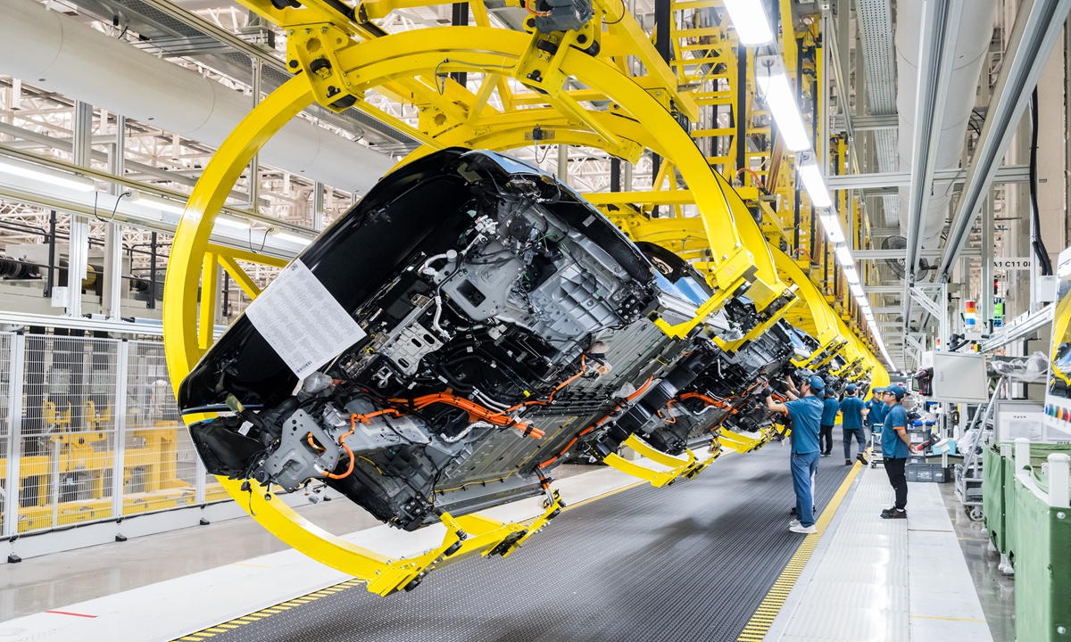 Workers check the production process at a Seres Group's super factory in Southwest China's Chongqing city on May 20, 2024. Photo: Chen Tao/GT