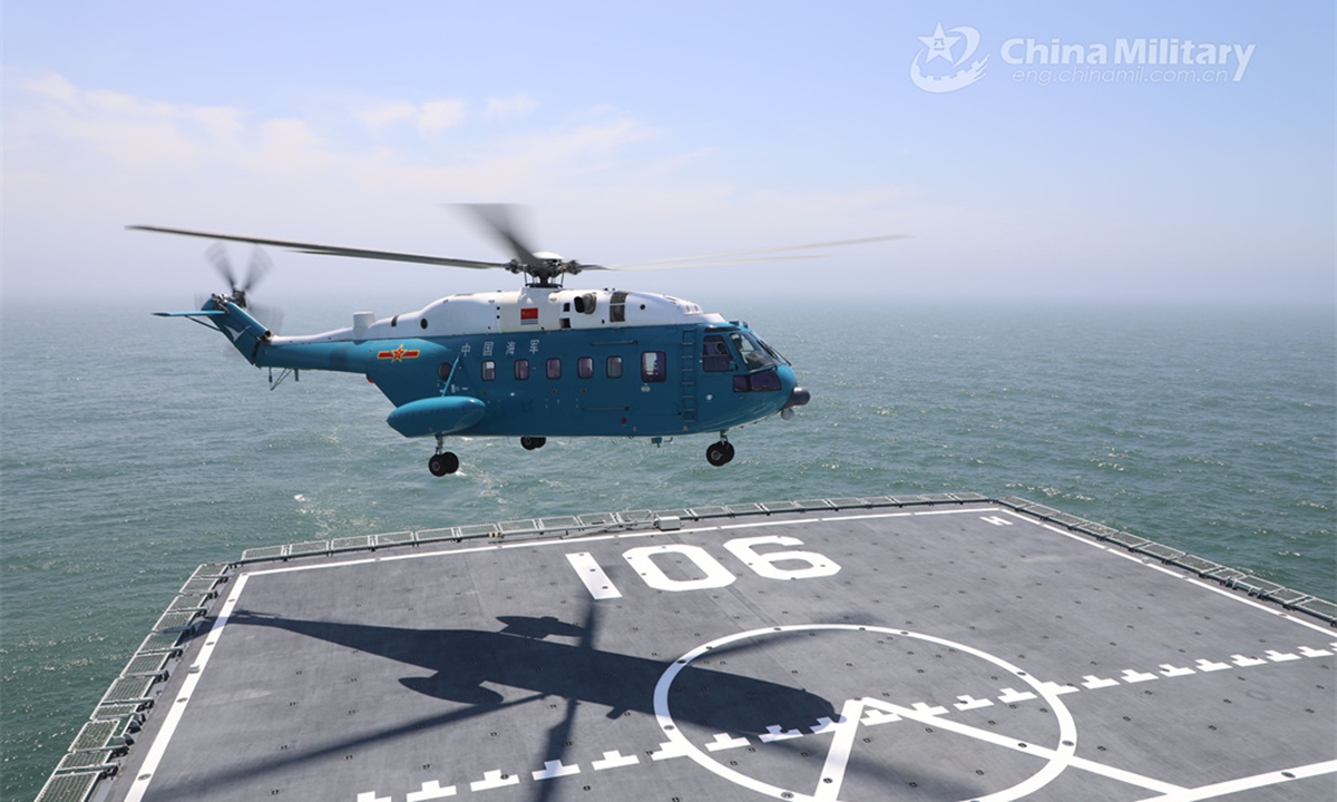 A ship-borne helicopter attached to a combat support ship flotilla with the navy under the PLA Northern Theater Command prepares to land on the flight deck of the Type 901 comprehensive supply ship Hulunhu during a maritime training exercise on June 14, 2024. (eng.chinamil.com.cn/Photo by Xu Taotao)