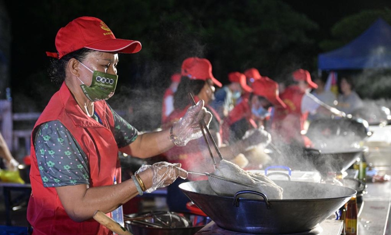 Competitors make Lingshui sour rice noodles during a sour rice noodle cooking competition in Lingshui, south China's Hainan Province, July 26, 2024. Lingshui sour rice noodle is a popular local snack and was listed as a provincial-level intangible cultural heritage in 2009. Recently a cooking competition was held in Lingshui to promote the sour rice noodle industry. Photo: Xinhua