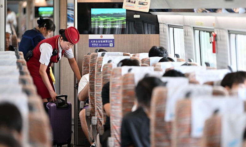 A train attendant works on the G8844 bullet train of a railway connecting north China's Tianjin Municipality with the Beijing Daxing International Airport on July 6, 2024. Photo: Xinhua