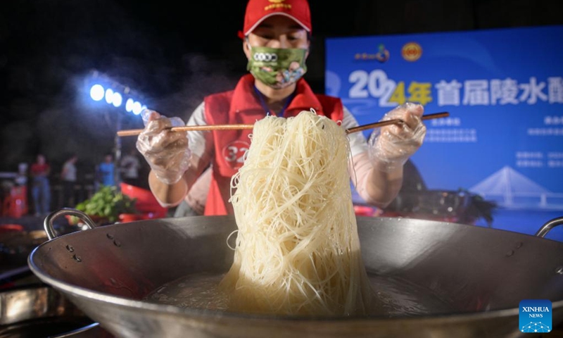 A competitor makes Lingshui sour rice noodles during a sour rice noodle cooking competition in Lingshui, south China's Hainan Province, July 26, 2024. Lingshui sour rice noodle is a popular local snack and was listed as a provincial-level intangible cultural heritage in 2009. Recently a cooking competition was held in Lingshui to promote the sour rice noodle industry. Photo: Xinhua