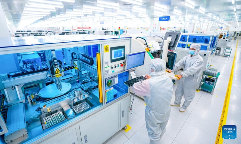 Staff members work on a production line of Accelink Technologies, an opto-electronic components supplier, in Wuhan, central China's Hubei Province, Feb. 5, 2024. Wuhan East Lake High-tech Development Zone, also known as the optics valley of China, is the birthplace of China's first optical fiber and a national optoelectronic information industry base. In recent years, Hubei Province has made major breakthroughs in the development of optoelectronic information industry and accelerated the building of optoelectronic information industry clusters. Photo: Xinhua