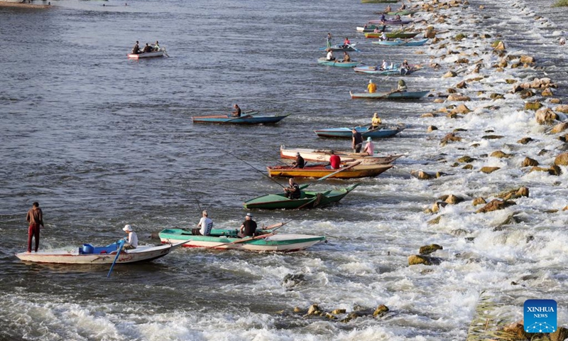 Fishermen fish at a waterfall in the Nile River in Qalyubia Governorate, Egypt, on July 6, 2024. Hundreds of amateur and professional fishermen gathered here to fish and escape the heat during hot summer. Photo: Xinhua