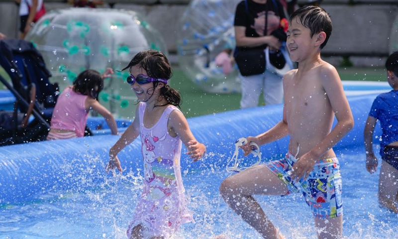 Children enjoy splashing in an outdoor inflatable pool during the 2024 Chinese Cultural Heritage Festival and Vancouver Water Splashing Festival in Burnaby, British Columbia, Canada, July 27, 2024. The two-day events kicked off here on Saturday. Photo: Xinhua